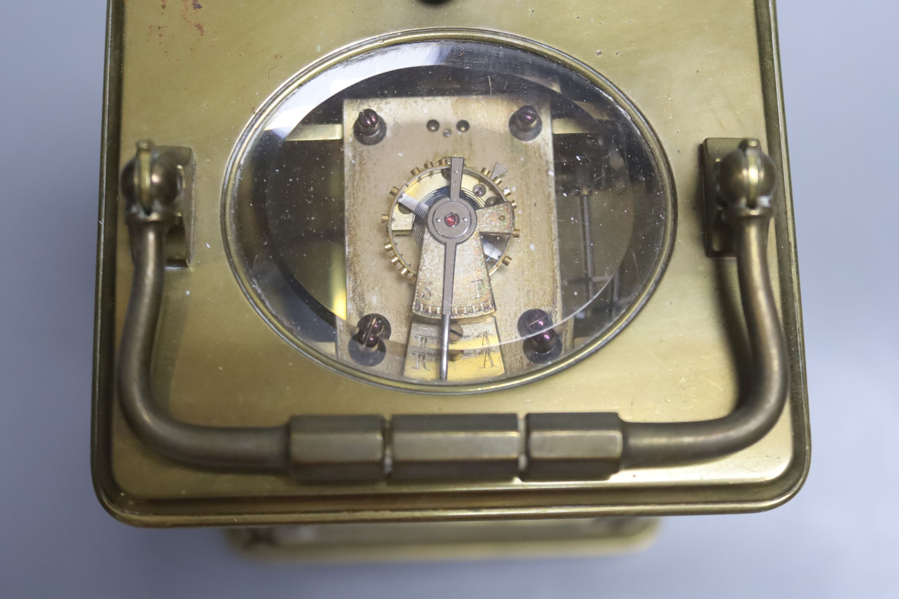 A 19th century brass hour repeating carriage clock, by Henri Jacot, height 15cm with handle down